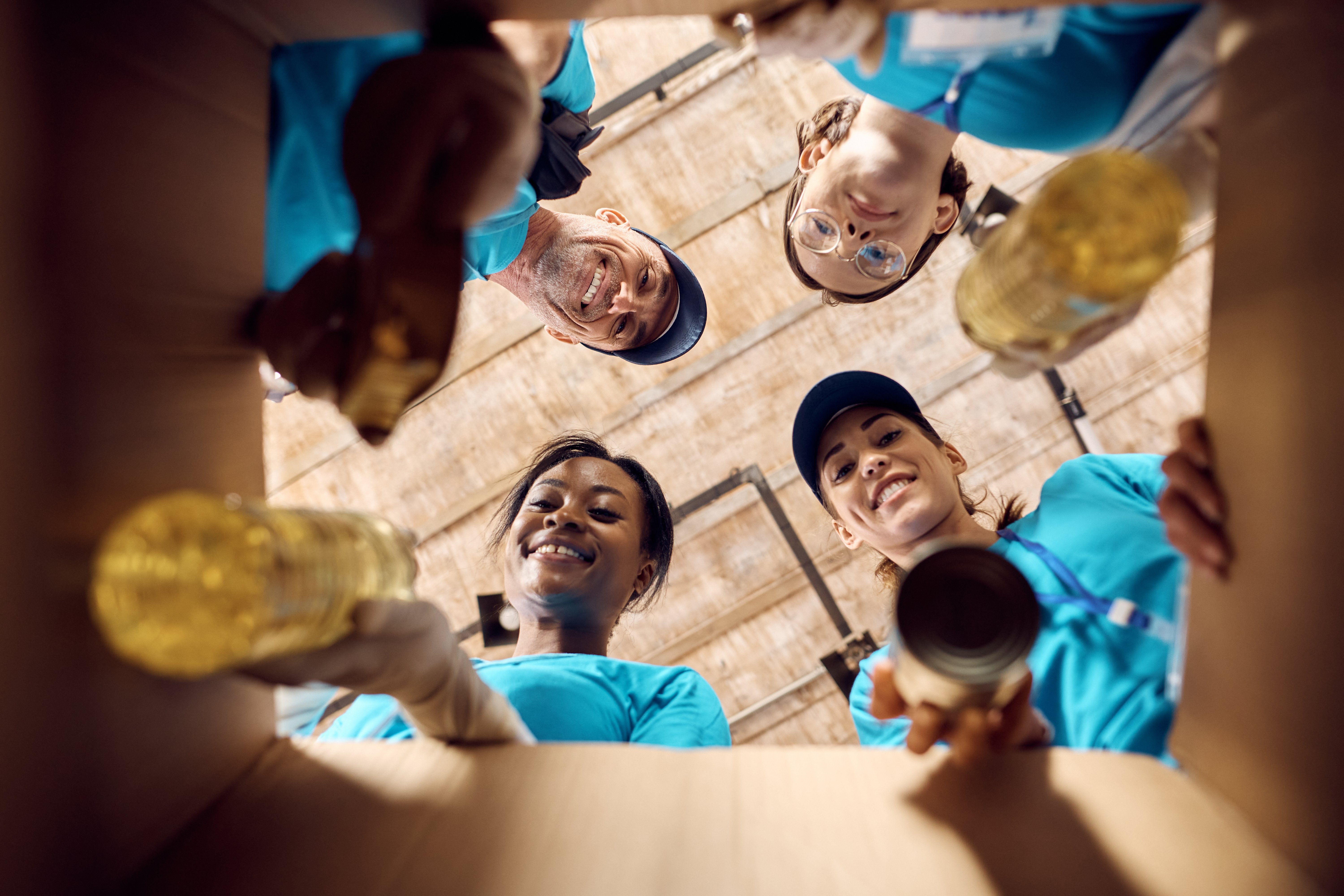 below-view-of-volunteers-packing-donated-food-in-c-2024-12-13-21-42-06-utc